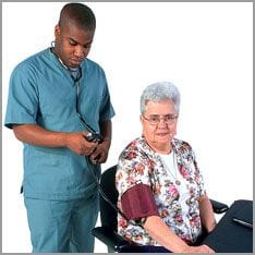 Man measures blood pressure of elderly woman