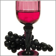 Wine in a glass with grapes
