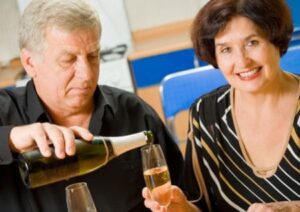 Elderly couple drinking wine