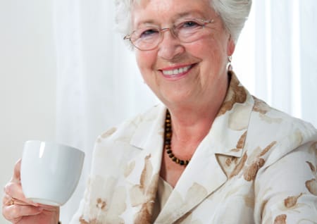 Coffee against Alzheimer's elderly lady drinking coffee