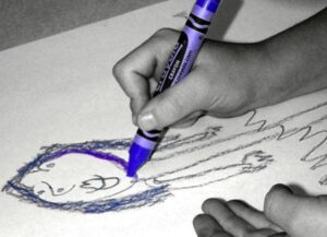 Child drawing with blue pencil