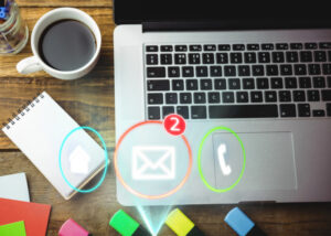 Laptop with coffee, notes and mail icons